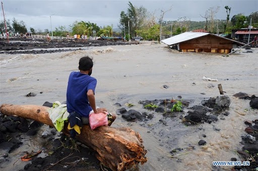 A man looking at the floods after typhoon Goni hit the Philippines