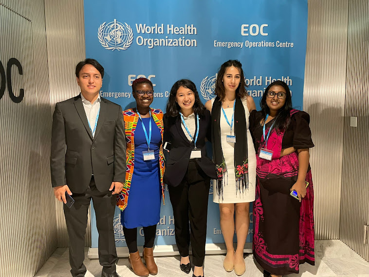 Group of five young people posing at the WHO headquarters.