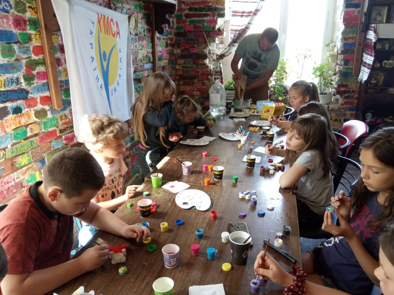 Kids in Ukraine doing crafts at a table