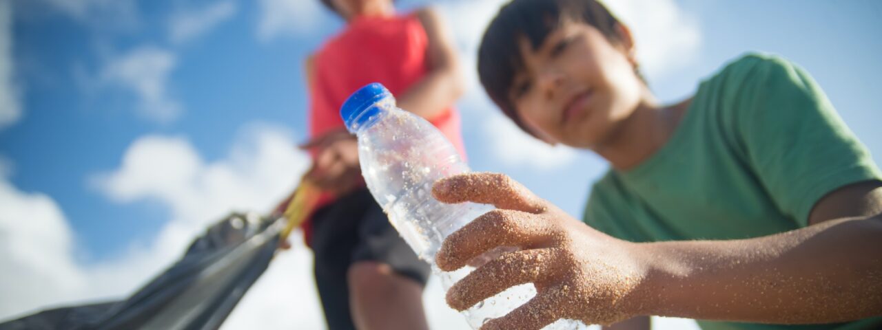 A child holding a plastic bottle