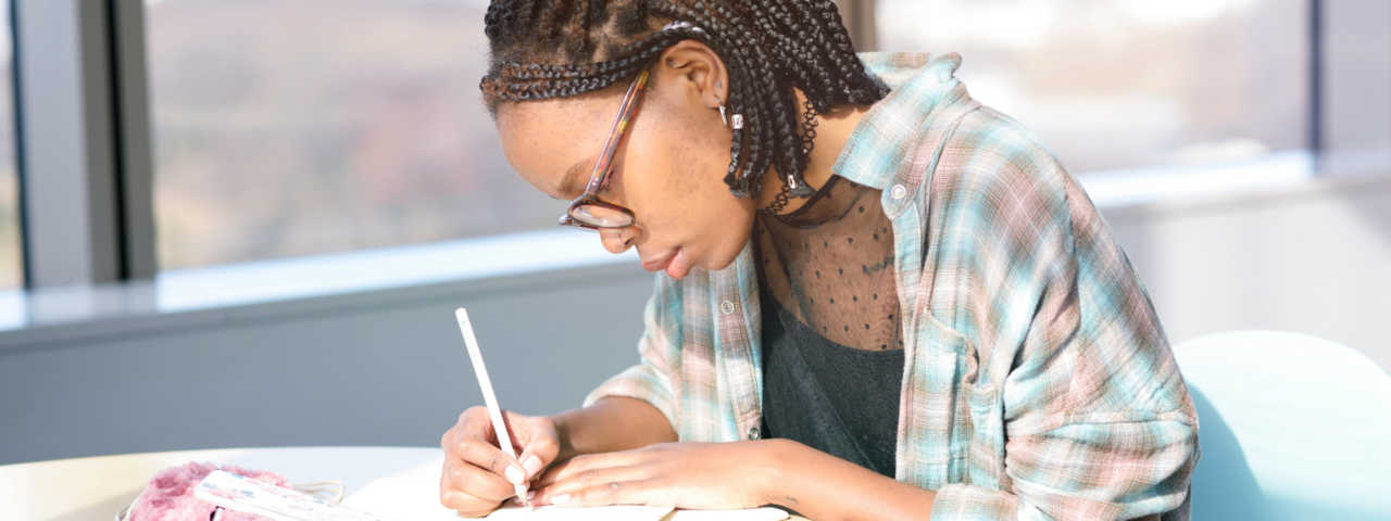 A woman using a pen on a piece of paper