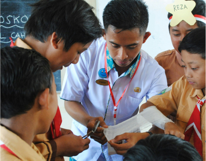 Group of people gathered around a paper